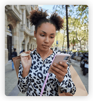 a woman on the street looking at her phone