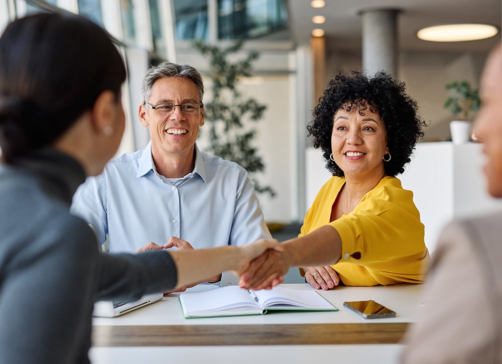 Business owner shaking hands with a Beem financial advisor