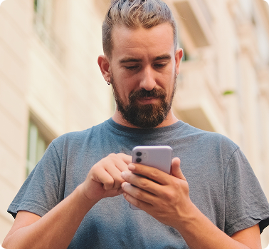 man-using-mobile-phone-in-city-setting
